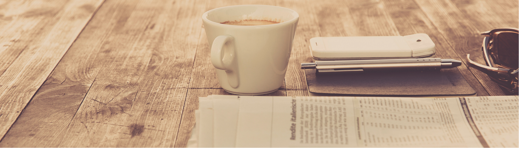 coffee on table with news paper